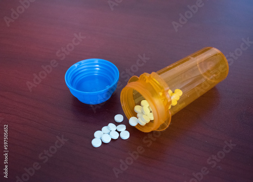 Open medicine bottle with pills