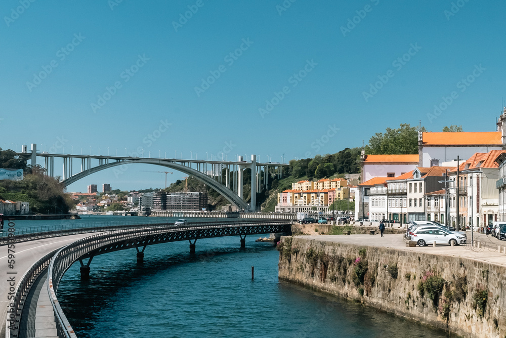 Oporto, Portugal. April 13, 2022: Cais das Pedras viaduct with cityscape and blue sky.