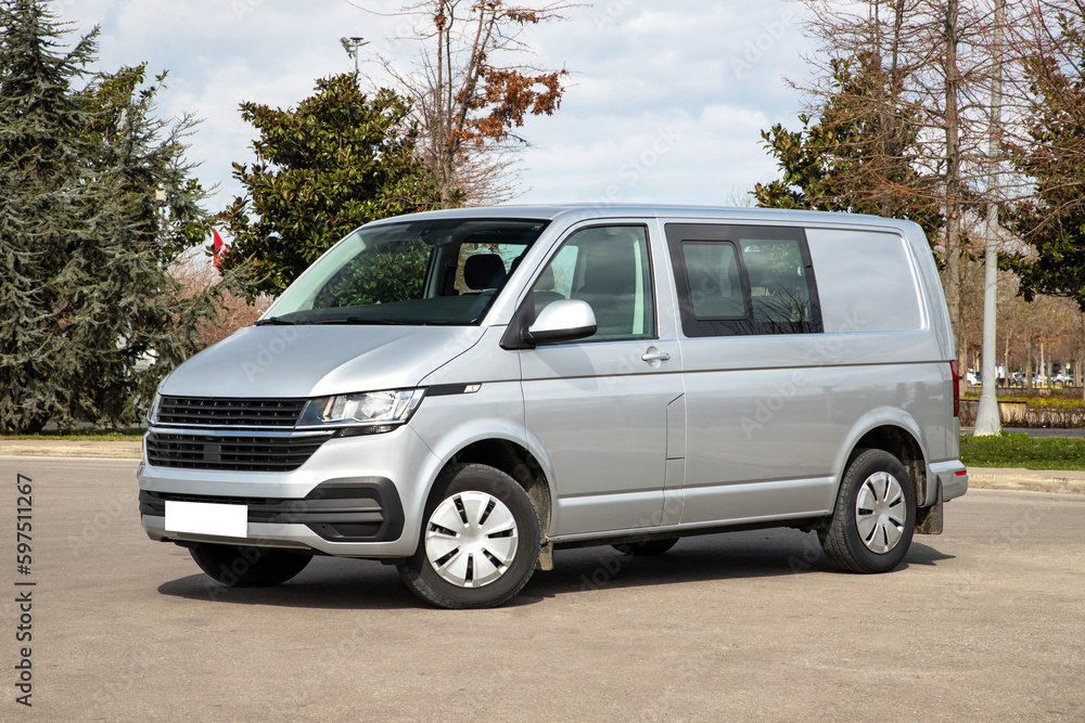 A grey van is parking in a car park, no logo.