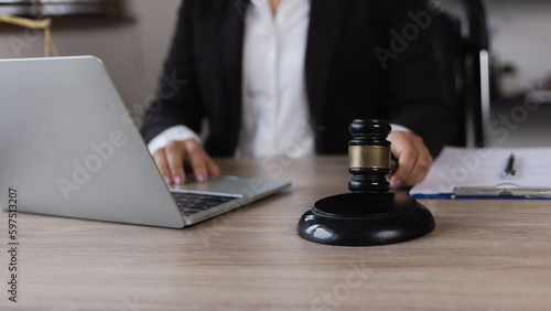 Advice and Legal services Concept. Judge gavel with Justice lawyers, Businesswoman in suit or lawyer working with laptop at desk.