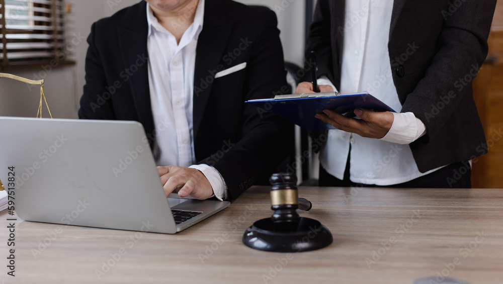 Close-up of asian lawyer and client discussing at office desk, law and justice concept. Close-up of asian lawyer and client discussing at office desk, law and justice concept.