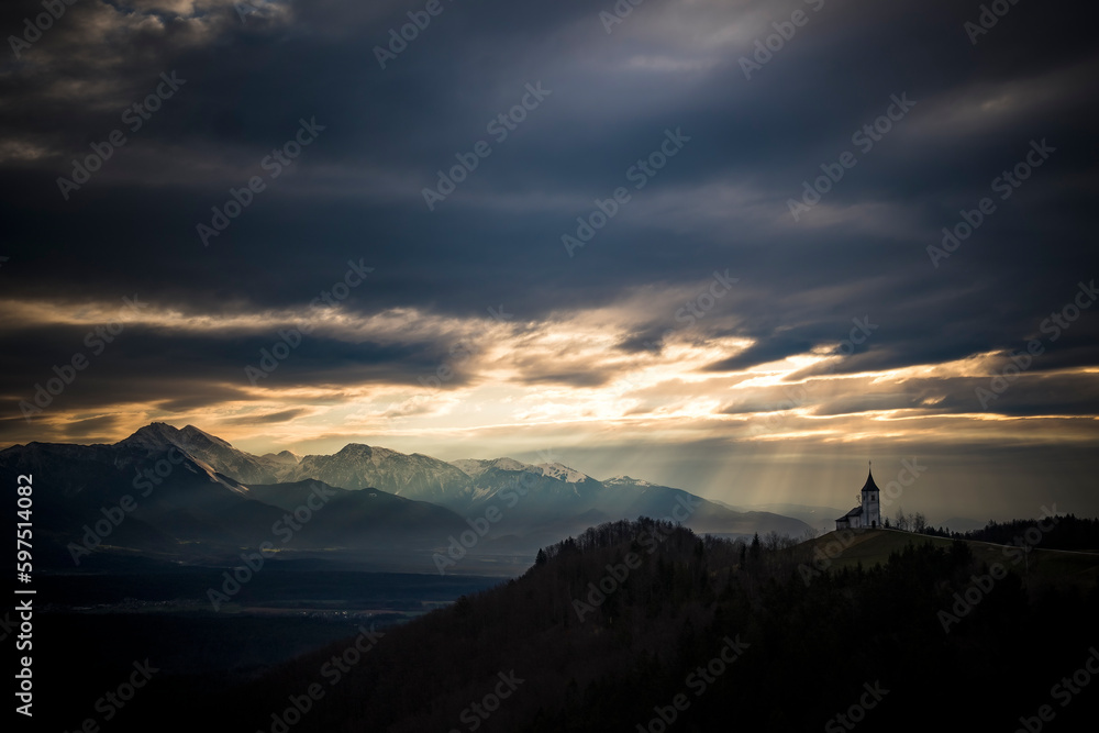 Dramatic early morning light over church in Slovenia Dramatic early morning light over church in Slovenia