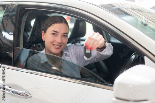 A young beautiful woman driving her car