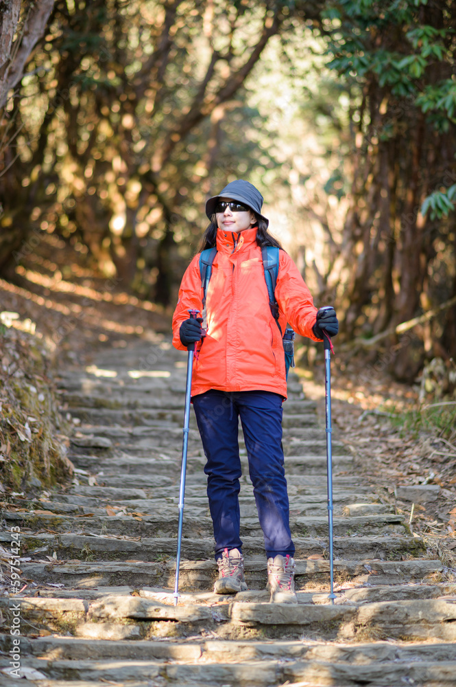 A young traveller trekking on forest trail , Nepal A young traveller trekking on forest trail , Nepal