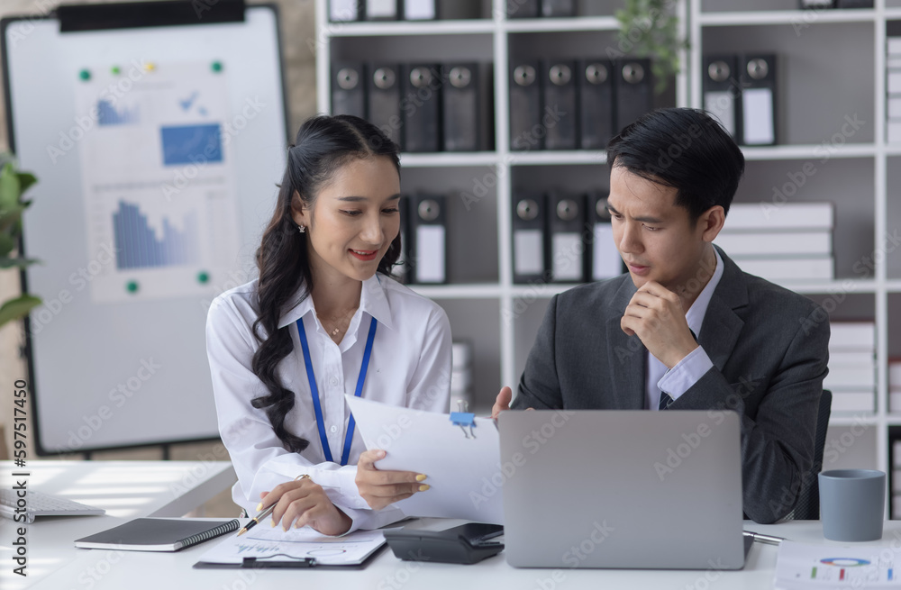 Two employees working at table in a modern office, Asian man and a woman work at office desk, Business campaign result and project planning concept, financial planning, Two employees working at table in a modern office, Asian man and a woman work at office desk, Business campaign result and project planning concept, financial planning,
