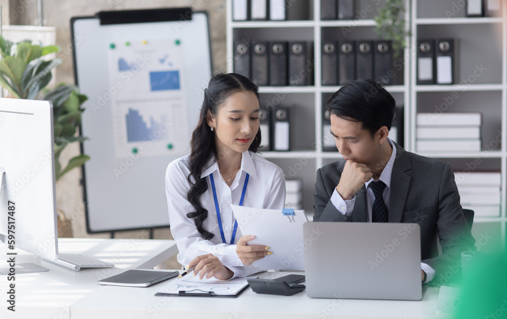 Two employees working at table in a modern office, Asian man and a woman work at office desk, Business campaign result and project planning concept, financial planning, Two employees working at table in a modern office, Asian man and a woman work at office desk, Business campaign result and project planning concept, financial planning,