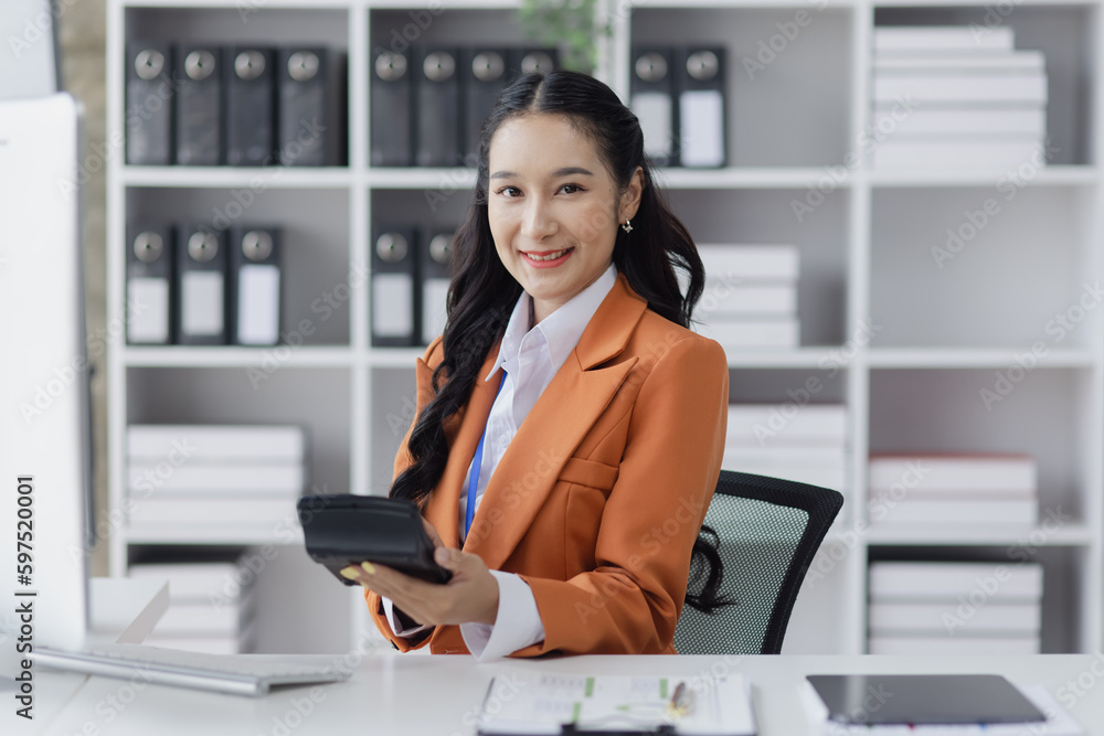 Asian businesswoman working on e-Commerce project marketing, Business and investment finance with growth graph. Asian businesswoman working on e-Commerce project marketing, Business and investment finance with growth graph.