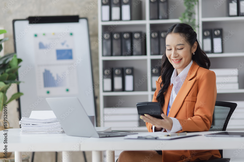 Asian businesswoman working on e-Commerce project marketing, Business and investment finance with growth graph. Asian businesswoman working on e-Commerce project marketing, Business and investment finance with growth graph.