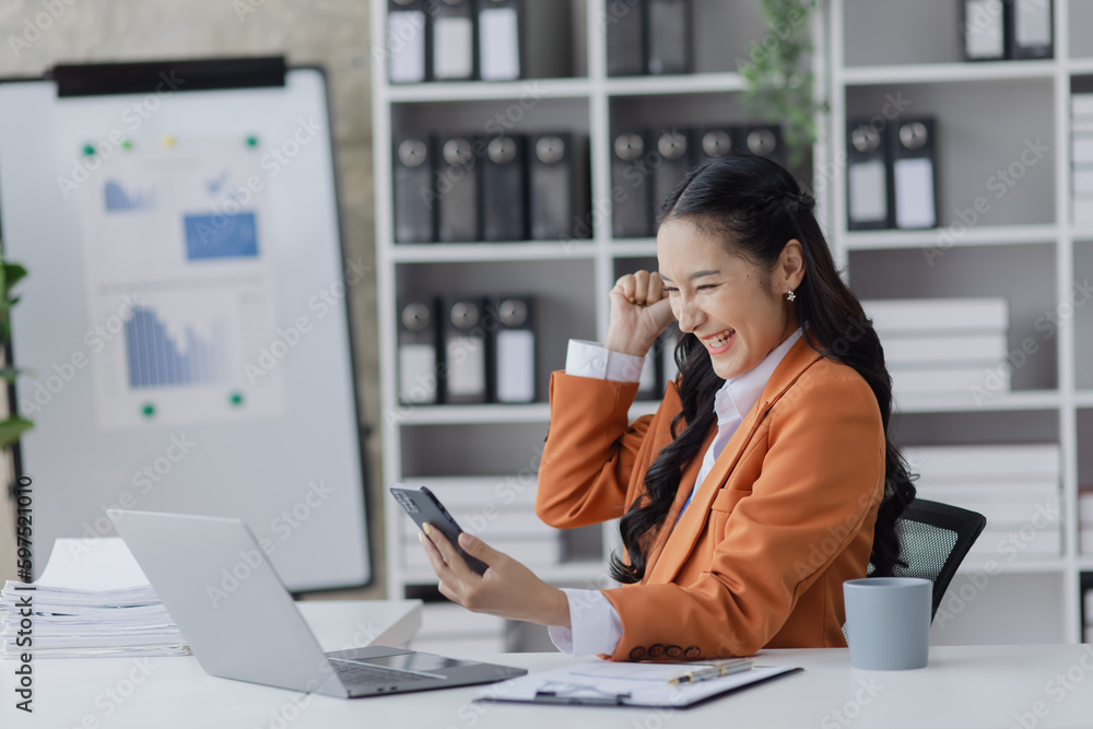 Young happy Asian business woman, Celebrate success in start up office, Excited woman. Young happy Asian business woman, Celebrate success in start up office, Excited woman.