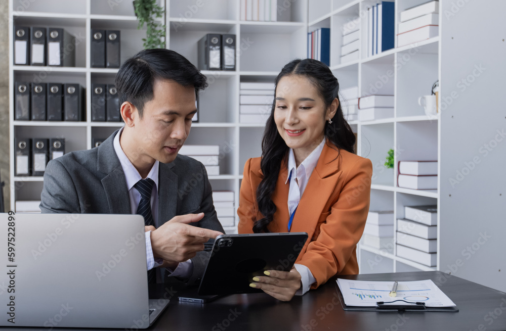 Two employees working at table in a modern office, Asian man and a woman work at office desk, Business campaign result and project planning concept, financial planning, Two employees working at table in a modern office, Asian man and a woman work at office desk, Business campaign result and project planning concept, financial planning,