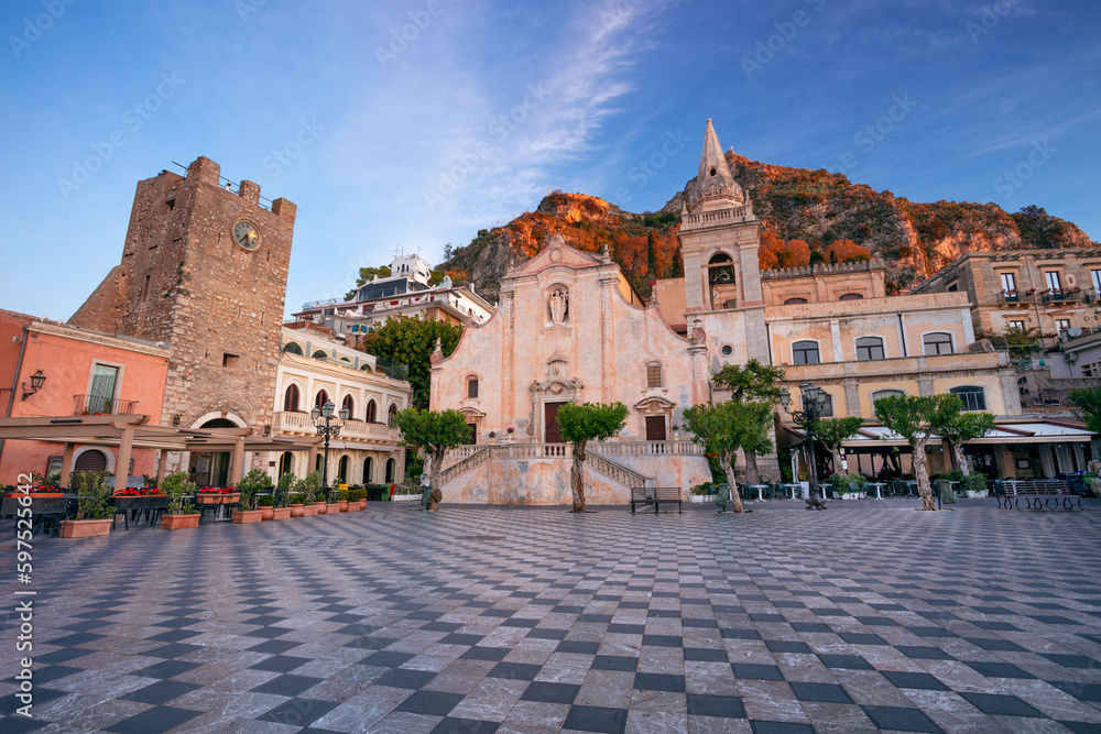 Taormina, Sicily, Italy. Cityscape image of picturesque town of Taormina, Sicily with main square Piazza IX Aprile and San Giuseppe church at sunrise.