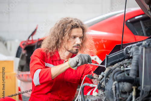 Technician man working in auto repair shop, Car mechanic in repair garage, Car repair and maintenance concepts