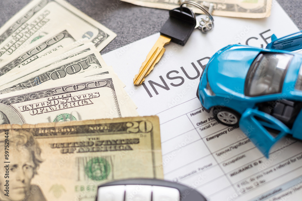 Car insurance form with car key and toy car