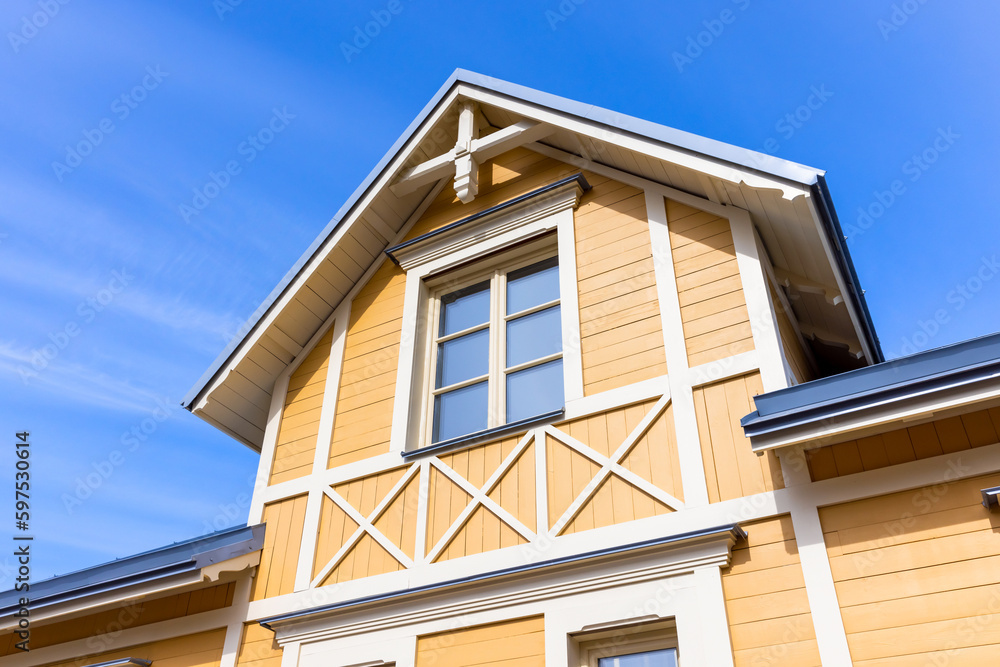 New wooden country house exterior fragment, yellow facade