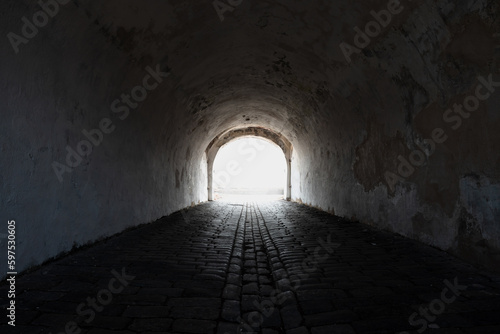 Perspective view of an empty tunnel with glowing end