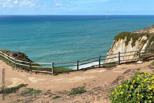 Panorama of the ocean coast and rock bay, Atlantic Ocean, beautiful cloudscape, dramatic landscape, colorful seascape with sheer rocks, travel content, Lisbon, Portugal © Elena