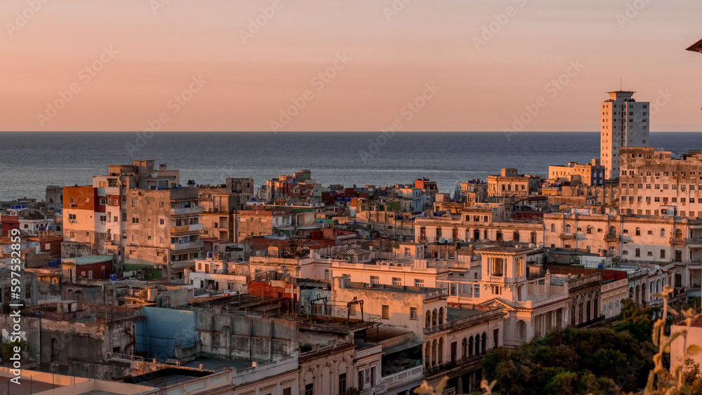 View over the rooftops of Havana in Cuba at sunset with the sea