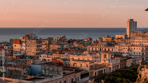 View over the rooftops of Havana in Cuba at sunset with the sea © Nicolas VINCENT