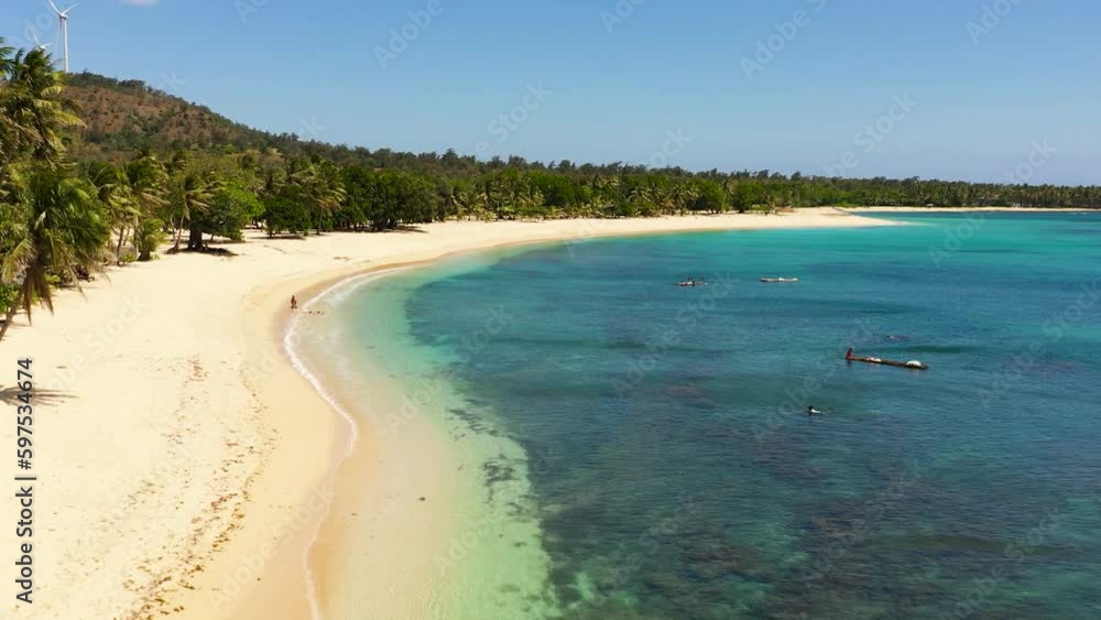 Beautiful beach, palm trees by turquoise water view from above. Pagudpud, Ilocos Norte Philippines Beautiful beach, palm trees by turquoise water view from above. Pagudpud, Ilocos Norte Philippines