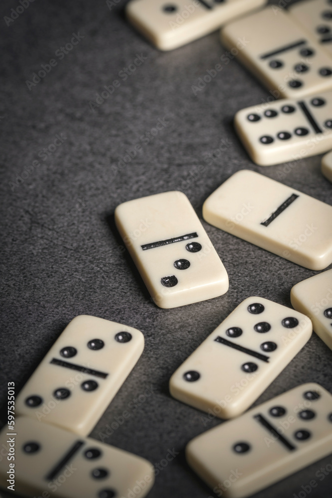 several tiles of classic dominoes on a dark background several tiles of classic dominoes on a dark background