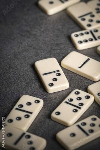 several tiles of classic dominoes on a dark background