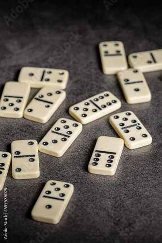 several tiles of classic dominoes on a dark background