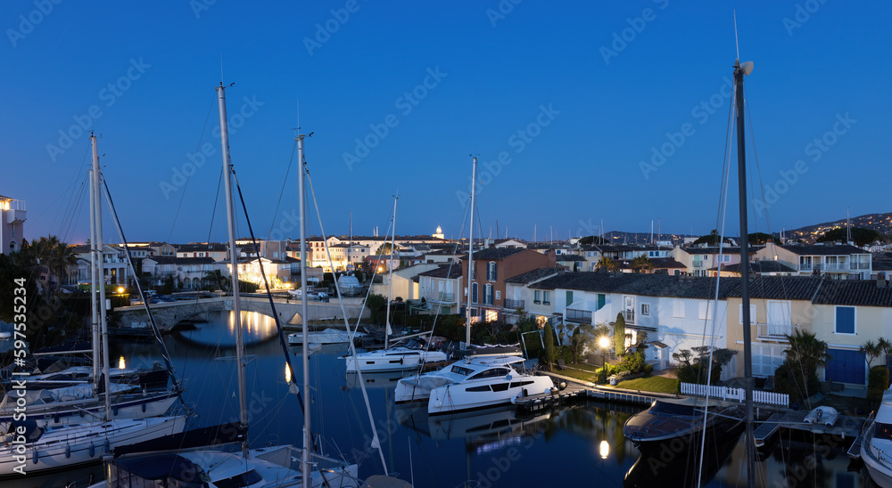 View over Port Grimaud marina in France in spring with yachts and sailing boats at evening