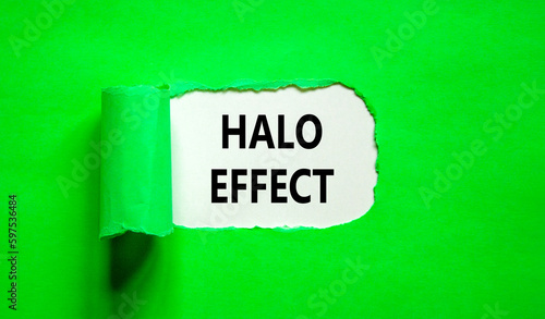 Halo effect and psychological symbol. Concept words Halo effect on beautiful white paper. Beautiful green table green background. Business psychological and Halo effect concept. Copy space.