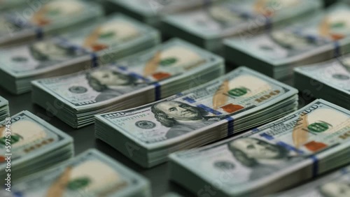 Stacks of One hundred dollar bills in even rows