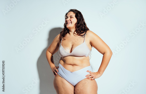 Plus size woman posing in studio in lingerie