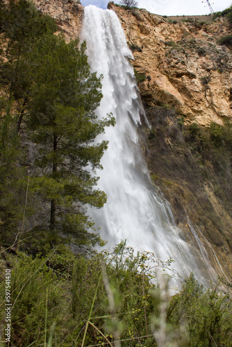 Paisaje con la cascada de el Salt en Alcoy con pinos en primer plano. Espa  a