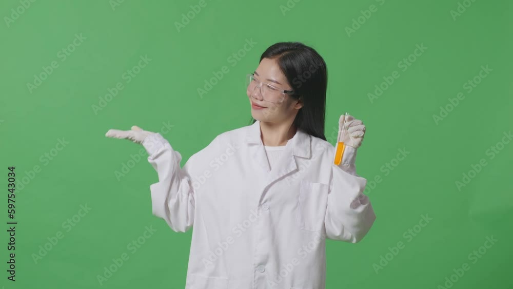 Asian Woman Scientist With Orange Liquid In The Test Tube Smiling And Pointing To Side While Standing On The Green Screen Background In The Laboratory
Asian Woman Scientist With Orange Liquid In The Test Tube Smiling And Pointing To Side While Standing On The Green Screen Background In The Laboratory