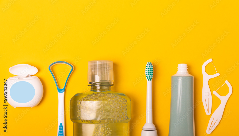 Sonic electric toothbrush, toothpaste, mouthwash, dental floss and tongue  cleaner on yellow background. Oral hygiene. Dental care.Dentistry  concept.Place for text.Place for copy. Stock Photo | Adobe Stock