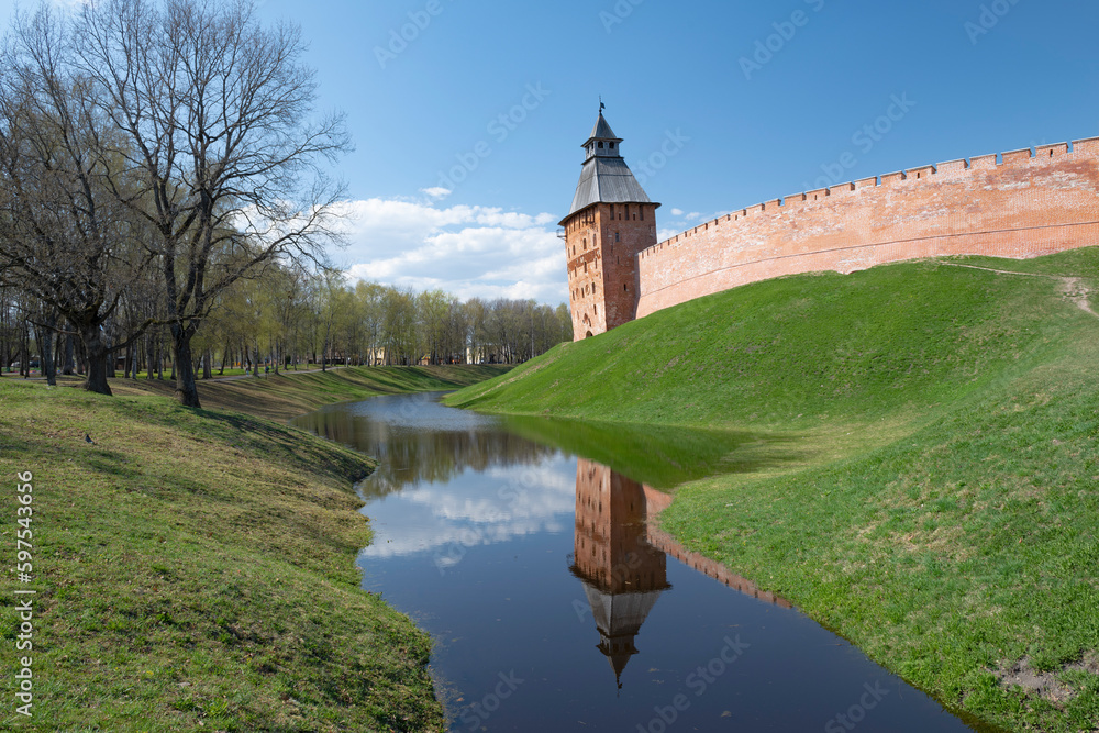 Ancient Spasskaya tower in a spring landscape on a sunny April day. Kremlin of Veliky Novgorod, Russia