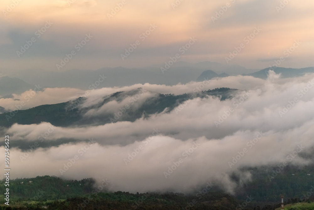 Beautiful view of clouds and mist covering mountain ranges in the Himalayan village of Chaukori in Kumaon.