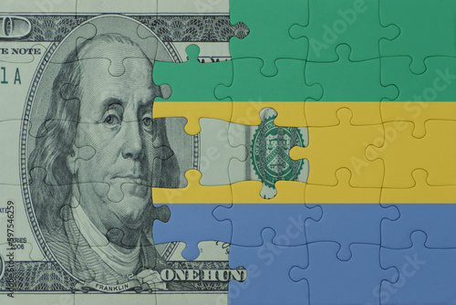 Wallpaper Mural puzzle with the national flag of gabon and dollar money banknote. macro.concept. Torontodigital.ca