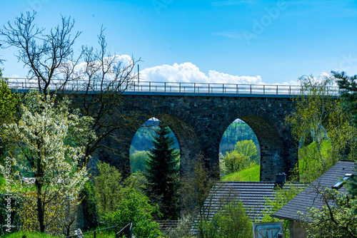 Historic stone railway viaduct on a sunny day against a blue sky