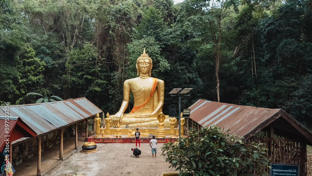 golden buddha statue in the forest golden buddha statue in the forest