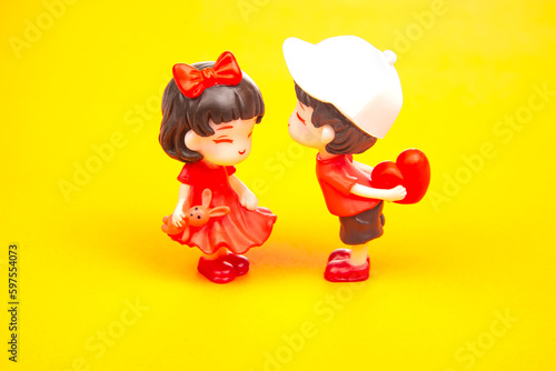 miniature people. figures for the game. romantic couple of young people. A boy lovingly gives his heart to a cute girl © photosaint