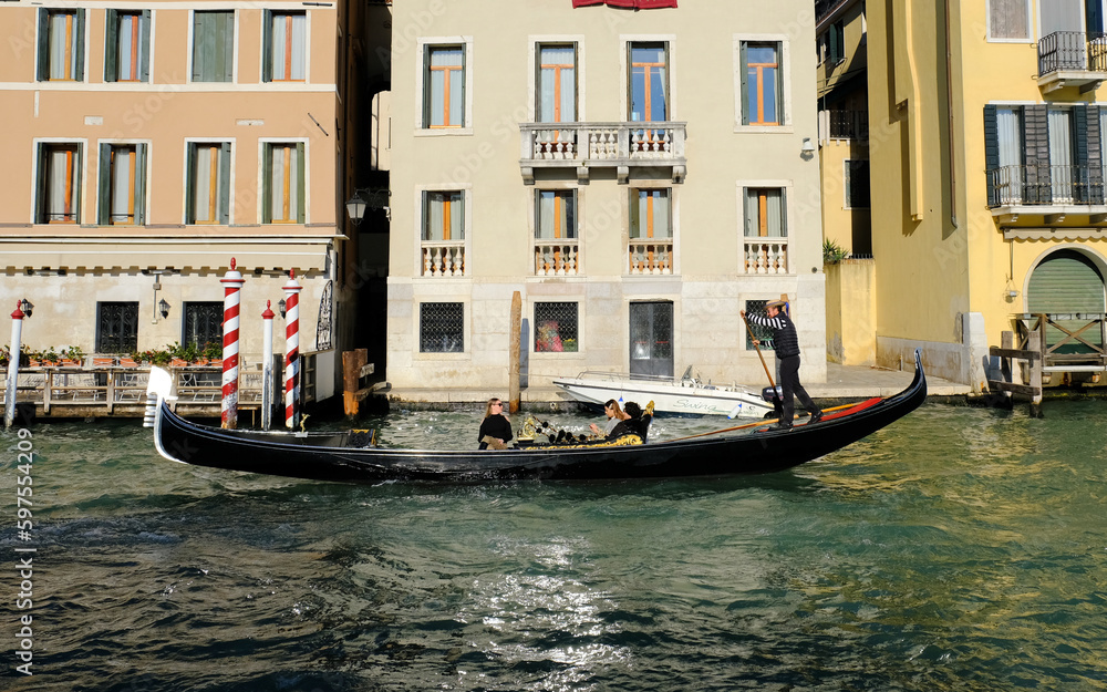 Gondola navigating through canal in Venice, Italy