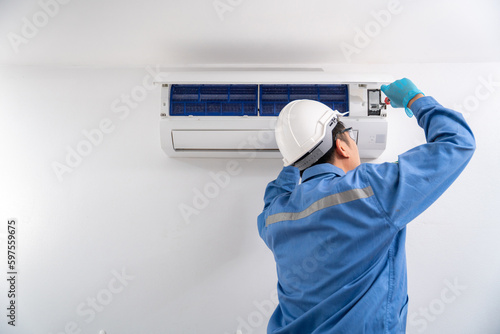 Air Conditioning Technician Repairing Air Conditioner and install new air conditioner. Service concept of an air conditioner technician.