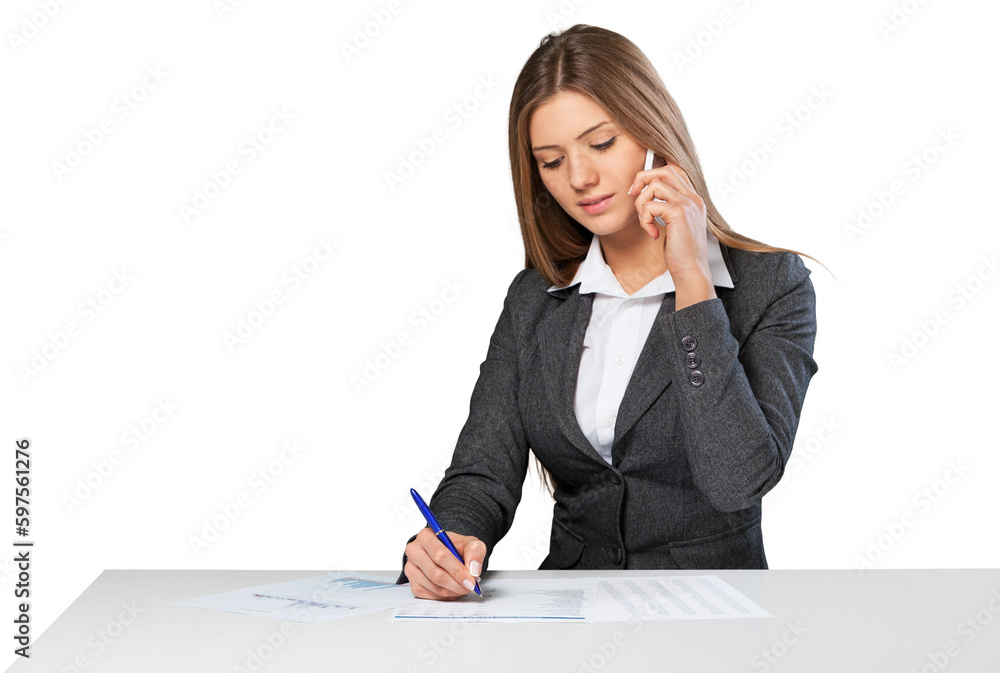 Business woman sitting at the white table and make notes Business woman sitting at the white table and make notes