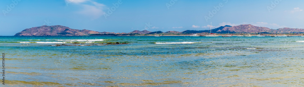 A panorama view past islets across the bay at Tamarindo in Costa Rica in the dry season