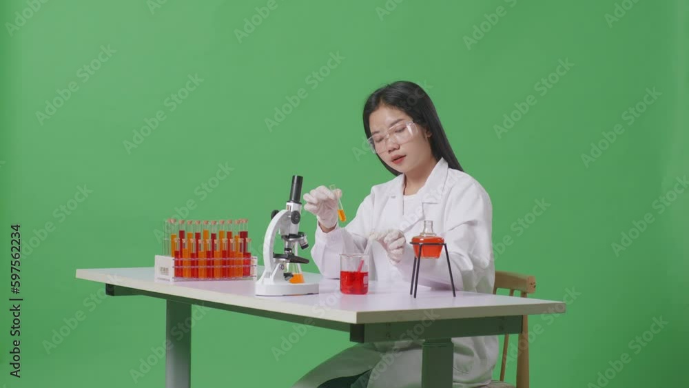 Side View Of Asian Woman Scientist Sitting And Making Experiment With Test Tube On The Table With Microscope In The Green Screen Background Laboratory
Side View Of Asian Woman Scientist Sitting And Making Experiment With Test Tube On The Table With Microscope In The Green Screen Background Laboratory