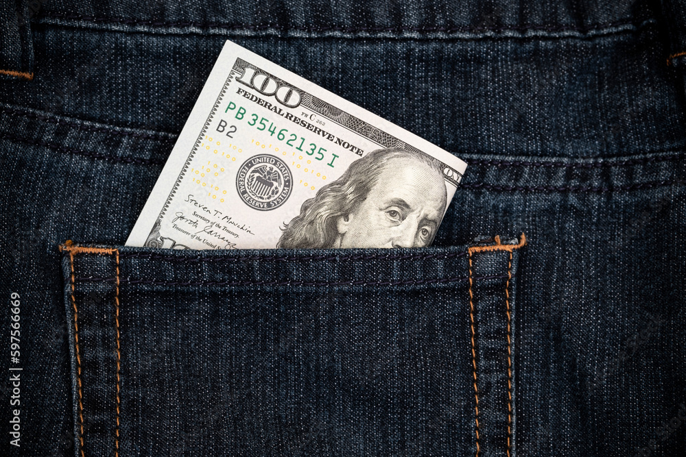 Several 100 us dollar bills in the pocket of jeans close up Several 100 us dollar bills in the pocket of jeans close up