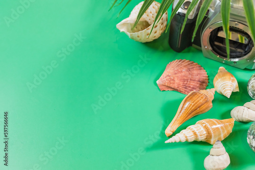The beach accessories on the green background. Summer is coming concept. photo