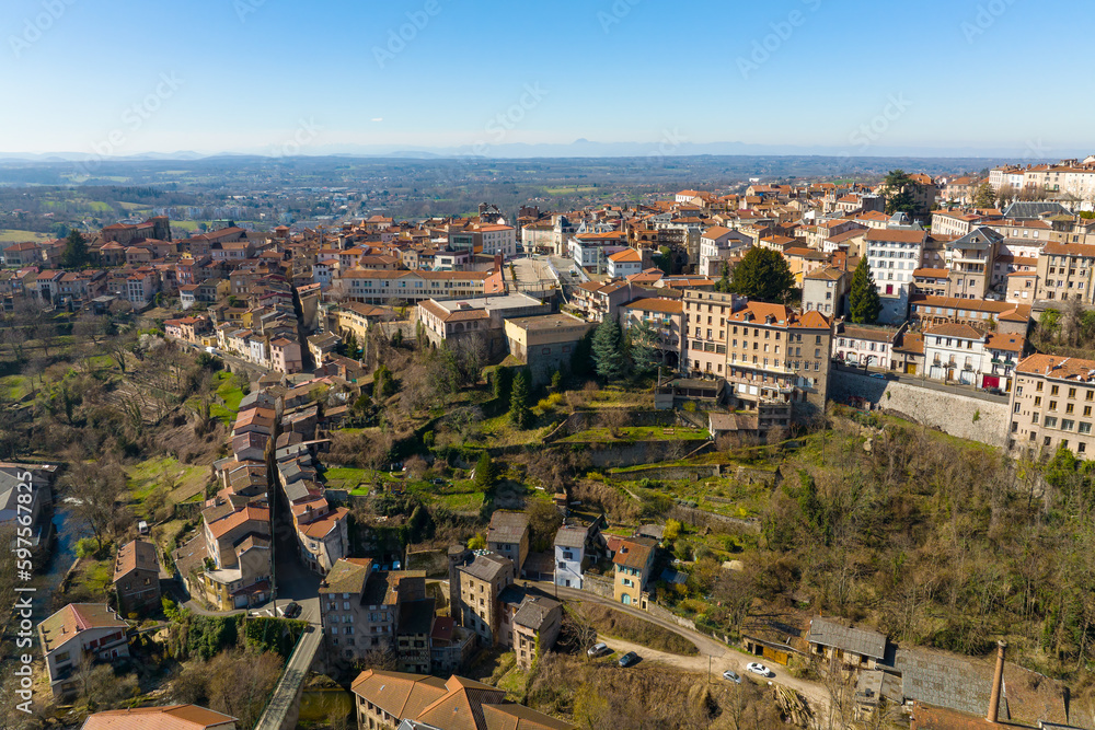 Aerial view of dense historic center of Thiers town in Puy-de-Dome department, Auvergne-Rhone-Alpes region in France. Rooftops of old buildings and narrow streets
