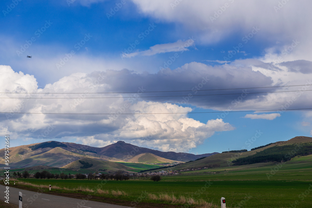 Fototapeta premium Panoramic landscape with snowy mountains and dramatic clouds