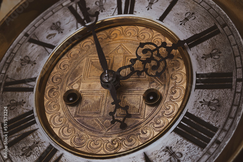 Old wooden clock with a pendulum hanging on the wall © Alexander Odessa 