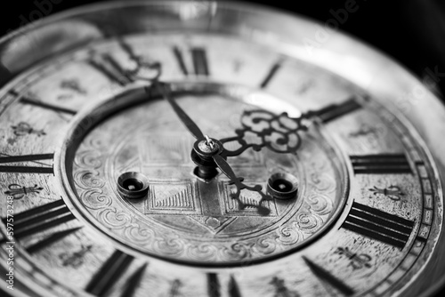Old wooden clock with a pendulum hanging on the wall	